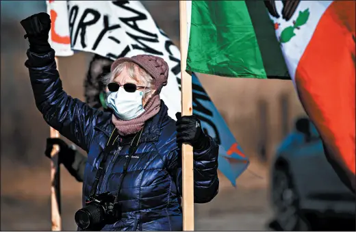  ?? KYLE TELECHAN/POST-TRIBUNE ?? Gary activist Ruth Needleman holds a fist aloft during a protest of deportatio­ns at Gary/Chicago Internatio­nal Airport on Friday.
