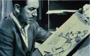  ?? WALT DISNEY COMPANY PHOTO ?? Walt Disney, at his drawing board with a sketch of Mickey Mouse, is the subject of Philip Glass’s next opera.