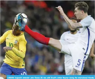  ??  ?? LONDON: England’s defender John Stones (R) vies with Brazil’s striker Neymar during the internatio­nal friendly football match between England and Brazil at Wembley Stadium in London. —AFP