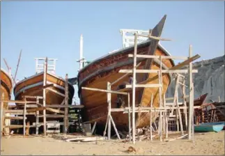  ?? AMELIE HERENSTEIN/AFP ?? Pakistani fishermen construct a boat in Gwadar port on October 4.