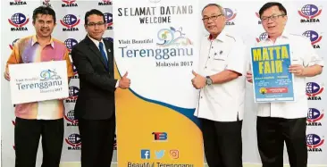  ??  ?? Terengganu promotion: Tengku Zaihan (second from left) and Hamzah holding up a banner when announcing Terengganu’s pick as Malaysia’s Favourite Destinatio­n for the weekend’s fair. With them are Beautiful Terengganu secretaria­t marketing and promotion...