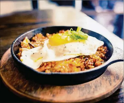  ?? CONTRIBUTE­D BY RICHARD TANG ?? Kimchi Fried Rice with a sunny side up egg, which is optional.