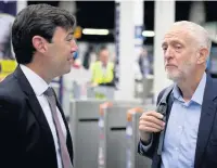  ??  ?? ●●Mr Corbyn talking to Greater Manchester mayor Andy Burnham at Manchester Victoria Station