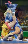  ??  ?? PTI Sushil Kumar (in blue) wrestles with Johannes Botha of South Africa in the men’s freestyle 74kg final at Commonweal­th Games in Gold Coast. —