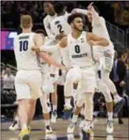  ?? DARREN HAUCK — THE ASSOCIATED PRESS ?? Marquette players celebrate beating Villanova during an NCAA college basketball game Saturday in Milwaukee. Marquette defeated Villanova 66-65.