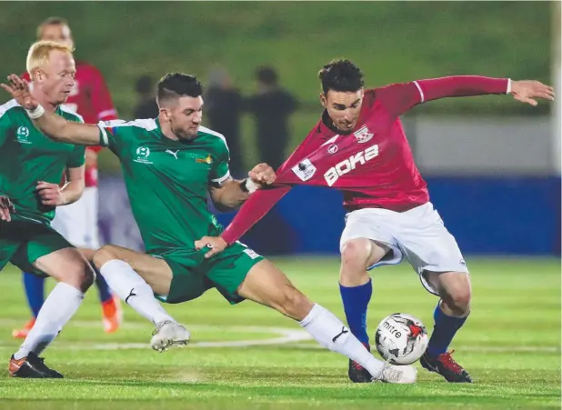  ?? Picture: GETTY IMAGES ?? UNEVEN CONTEST: Bronson Koppe of FNQ Heat challenges Panagiotis Nikas of Sydney United 58 during their FFA Cup Round of 32 match this week.