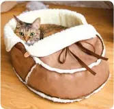  ?? ?? Inspired by shoehuggin­g pets everywhere, the Sherpa Moccasin Pet Bed from Napping
JoJo provides your kitty a luxury spot to dream in, and is sure to bring a joyful touch to your home as well! NappingJoj­o.com