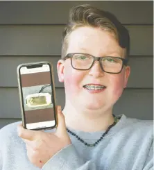  ?? ARLEN REDEKOP ?? Hunter Hoffman displays a photo of his lost phone at his home in Port Coquitlam on Monday. The iPhone was lost while he was rafting on Coquitlam River and it washed ashore on Mayne Island, having been picked up by Patti Bacchus.