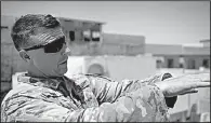  ?? AP/BALINT SZLANKO ?? Col. Pat Work with the U.S. Army’s 82nd Airborne Division refers to the skyline Friday as he meets with Iraqi commanders near the front lines on the rooftop of a house in Mosul.