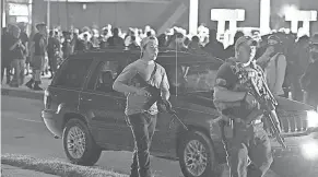  ?? ADAM ROGAN/THE JOURNAL TIMES VIA AP ?? Teenager Kyle Rittenhous­e, left, was charged with shooting three protesters in Kenosha, Wis., two of them fatally.