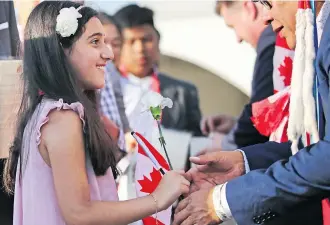  ??  ?? Nine year-old Enan Anchassi becomes a Canadian citizen during a citizenshi­p ceremony.