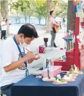  ??  ?? A busker makes a dough figurine, one of China’s intangible cultural heritage at Jing’an Park. — Wang Rongjiang