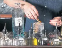  ?? ANDREW FRANCIS WALLACE/TORONTO STAR ?? Vincent Pollard prepares a gin and tonic with Isle of Harris. It has an aromatic, complex medley of botanicals so well integrated it can be challengin­g to pick out individual flavour notes, Christine Sismondo writes.