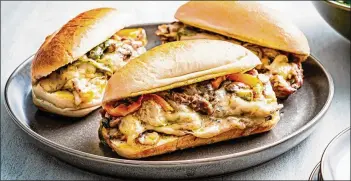  ?? SCOTT SUCHMAN FOR THE WASHINGTON POST ?? Sheet Pan Cheesestea­k, a rich sandwich, is definitely an occasional indulgence.