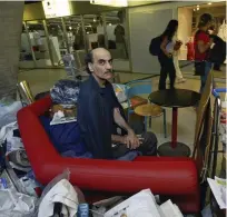  ?? ?? Mehran Karimi Nasseri sits among his belongings at Terminal 1 of Roissy Charles De Gaulle Airport, north of Paris. His saga inspired the Steven Spielberg film ‘The Terminal’. — ap file