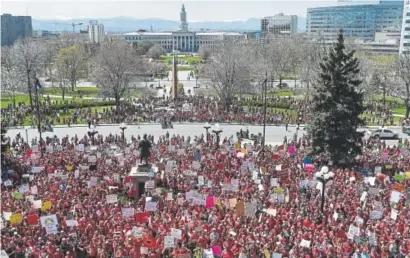  ?? Photos by AAron Ontiveroz, The Denver Post ?? Thousands of teachers gather outside the state Capitol to rally for more education funding. Friday’s event brought an estimated 6,000 educators from around the state. At top left, Alamosa High School teachers Louella Lenberg, left, and Susie Eabenson...