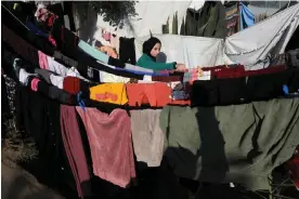  ?? Photograph: Anadolu/Getty ?? A Palestinia­n woman hangs her washing out in Khan Younis. For 700,000 women and girls in Gaza their period is a time of pain and humiliatio­n.
Images
