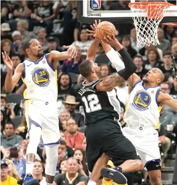  ?? Darren Abate photos/Associated Press ?? ■ San Antonio Spurs' LaMarcus Aldridge shoots against Golden State Warriors' David West and Kevin Durant during the first half of Game 4 of a first-round NBA playoff series Sunday in San Antonio. BELOW: Golden State Warriors’ West, center, shoots...
