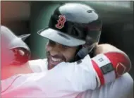  ?? ELISE AMENDOLA — THE ASSOCIATED PRESS ?? Boston Red Sox’s J.D. Martinez, right, hugs teammate Brock Holt (12) in the dugout after his solo home run against the Toronto Blue Jays in the fifth inning of a baseball game at Fenway Park, Monday in Boston.