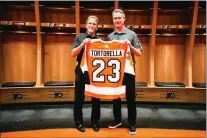  ?? SUBMITTED PHOTO — COURTESY OF PHILADELPH­IA FLYERS ?? New Flyers coach John Tortorella, left, is presented with jersey No. 23 by general manager Chuck Fletcher at his official introducti­on Tuesday as the club’s 23rd head coach.