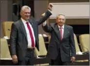  ?? IRENE PEREZ — CUBADEBATE VIA AP ?? Cuba’s new president Miguel Diaz-Canel, left, and former president Raul Castro, raise their arms after Diaz-Canel was elected as the island nation’s new president, at the National Assembly in Havana, Cuba, Thursday. Castro left the presidency after 12...