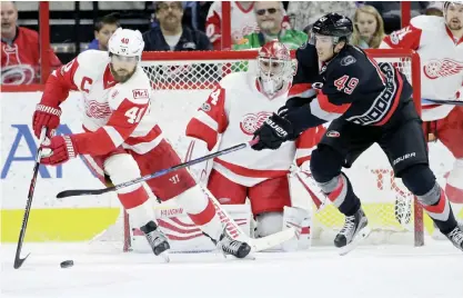  ??  ?? RALEIGH: Detroit Red Wings’ Henrik Zetterberg (40), of Sweden, controls the puck while Carolina Hurricanes’ Victor Rask (49), of Sweden, chases in front of Red Wings goalie Petr Mrazek (34), of the Czech Republic, during the first period of an NHL...