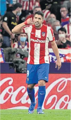  ?? AFP ?? Atletico Madrid’s Luis Suarez celebrates by making a phone gesture after scoring against Barcelona in the Spanish league this month.