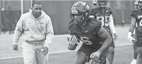  ?? JOSHUA MCCOY/OLE MISS ATHLETICS ?? Running backs coach Marquel Blackwell encourages Zach Evans at Ole Miss spring practice on March 22.