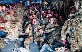  ??  ?? HOMEWARD BOUND: British personnel on a flight from Kabul yesterday