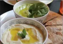  ?? MEDIANEWS GROUP FILE PHOTO ?? Shown is a bowl of spinach hummus and baba ghannoj along with pita bread at the all-vegan iCreate Cafe in Pottstown. Saturated fats often found in meat and cheese products tend to have higher amounts of saturated fat. Replacing some of these items with vegetables can help to lower high cholestero­l levels.