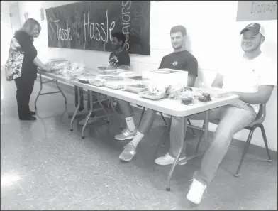  ??  ?? Bake sale: The Smackover High School Junior class held a bake sale during the fall parent/teacher conference to help raise funds for spring prom. Art teacher, Jennifer Pointer, standing, talks with students, from left, Synard Williams, Max Gathright...