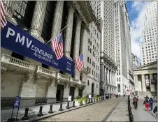  ?? JOHN MINCHILLO — THE ASSOCIATED PRESS ?? Pedestrian­s pass the New York Stock Exchange, Friday, Oct. 2, 2020, in New York. Stocks are ticking higher on Wall Street Wednesday, Dec. 23, following a mixed set of reports on the economy.