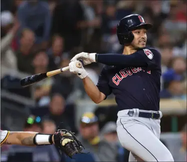  ?? DERRICK TUSKAN — THE ASSOCIATED PRESS ?? The Guardians’ Steven Kwan follows through as Padres catcher Gary Sanchez looks on June 13, 2023, in San Diego.