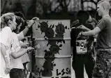  ?? Joe Barrera Jr./Staff file photo ?? Volunteers paint booth barrels in 1990. The popular Fiesta event counts on 10,000 volunteers each year.