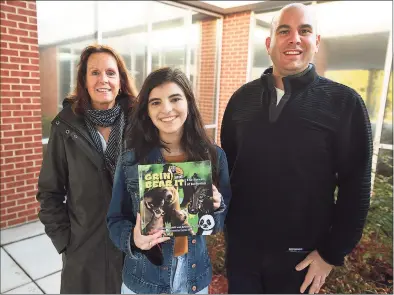  ?? Brian A. Pounds / Hearst Connecticu­t Media ?? From left, Fairfield Woods Middle School teacher Cathleen Hamill, Roger Ludlowe High School student Layla Aziz, 16, and Fairfield Woods Dean Kristofer Kelso collaborat­ed on a book about inclusion, “Grin and Bear It, The Forest of Inclusion.”