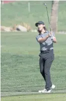  ??  ?? Tommy Fleetwood of England plays a shot with his wedge.