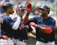  ?? D. Ross Cameron / Associated Press ?? The Red Sox’s Franchy Cordero, right, is greeted by teammates Xander Bogaerts (2) and Rafael Devers after hitting a three-run home run against the A’s on Sunday.