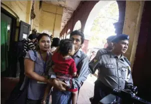  ?? AUNG KYAW HTET/AFP ?? Reuters journalist Kyaw Soe Oo (centre) kisses his daughter while walking in handcuffs after a bail hearing at a courthouse in Yangon on February 1.