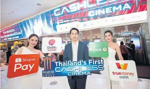  ??  ?? Major Cineplex launched its cashless cinema model at Quartier CineArt. Mr Narut, centre, says the company plans to expand this model to nine other branches in Bangkok by July 1.