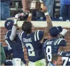  ?? JUSTIN FORD/USA TODAY SPORTS ?? Mississipp­i Rebels players celebrate after winning their game against the Mississipp­i State Bulldogs at Vaught-hemingway Stadium.