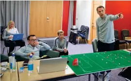  ??  ?? Pointing the way: women’s head coach Neville talks tactics with his technical staff in a meeting at St George’s Park