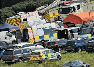  ?? PA PHOTOS. ?? A field above the accident site became the car park and base for rescuers, investigat­ors and the recovery team. NR now faces a difficult task recovering August 12‘s crash wreckage.