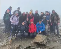  ??  ?? ● Members of the Heath Gym at the summit of Snowdon as part of its ‘awayday’