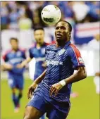  ?? Eugene Hoshiko / Associated Press ?? Shanghai Shenhua’s Didier Drogba controls the ball during a soccer match against Hangzhou Greentown at Hongkou Football Stadium on Aug. 4, 2012 in Shanghai, China.