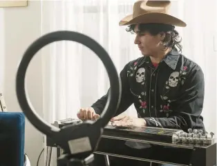  ?? ?? Noah Faulkner, known as Pedal Steel Noah, practices his pedal steel guitar, which is one of the hardest instrument­s to master.