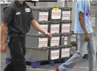  ?? Ethan Miller / Getty Images ?? NEVADA: Boxes of mail ballots are stacked at the county Election Department in North Las Vegas in a race that remains too close to call in the state.