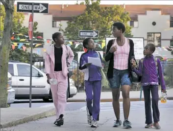  ?? Richard Drew/Associated Press ?? Tonia Handy and her children, Tai Sheppard, Rainn Sheppard and Brooke Sheppard, left to right, walk home after track workouts in Brooklyn, N.Y., in 2016. The family was able to move out of a homeless shelter and into a two-bedroom apartment in April.