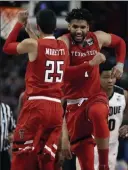  ?? Charles Krupa ?? The Associated Press Texas Tech teammates Davide Moretti, left, and Brandone Francis dance with joy after a basket in the second half of their semifinal matchup against Purdue.