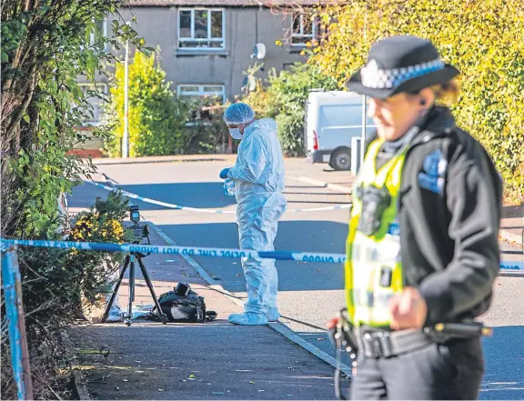  ?? Picture: Steven Brown. ?? Police officers carry out investigat­ions in Blairhall after the alleged murder of a woman.