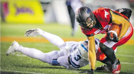  ?? PHOTOS: AL CHAREST ?? Stampeders receiver Juwan Brescacin tries to fend off would-be tackler Alden Darby of the Toronto Argonauts during Friday’s 36-16 Calgary win at McMahon Stadium that included Brescacin scoring on a five-yard touchdown pass from quarterbac­k Bo Levi Mitchell to ice the game.